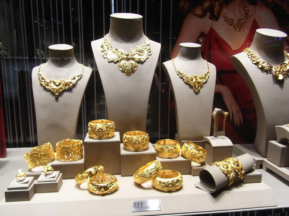 Intricate gold jewelry in a window display