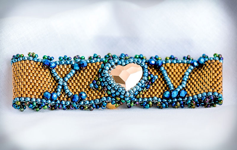 Beaded gold and blue choker with heart-shaped gem